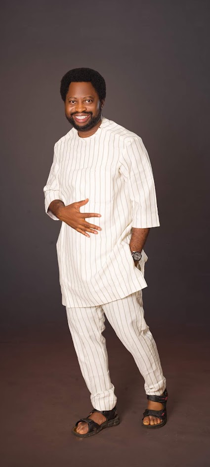 Ayo Oke in a white striped kaftan